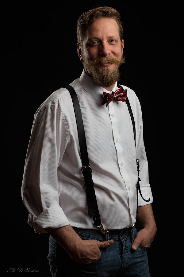 studio portrait man with beard and suspenders