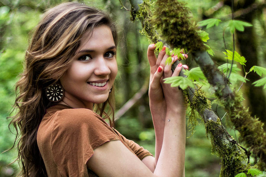 environmental portrait young woman smiling in nature