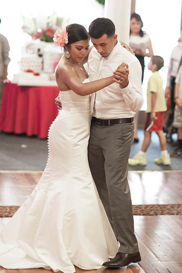 bride and groom holding hands at indoor wedding reception