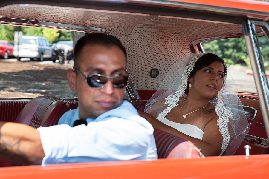 bride and chauffeur looking toward church from car